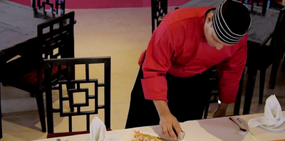 A waiter serving food at Playa Blanca Beach Resort
