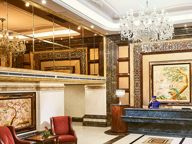 luxurious hotel lobby with reception desk and glass chandelier
