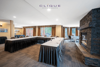 Meeting room at Falcon Crest Lodge is set up with a U-shaped conference table and chairs, ready for presentations