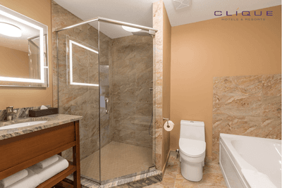 Bathroom in a suite at Falcon Crest Lodge features a spacious glass-enclosed shower, a toilet