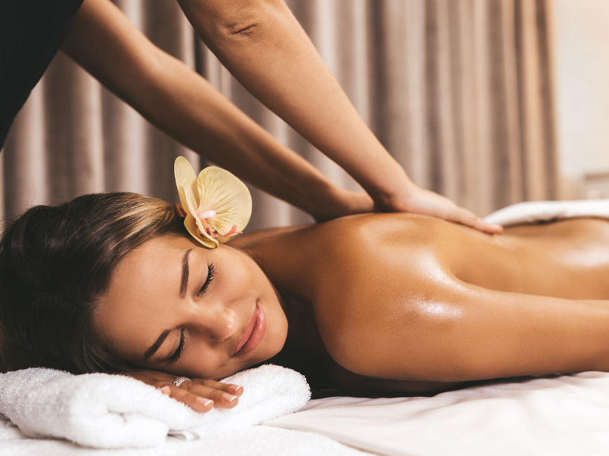 woman having back massage in spa at Amora Hotel