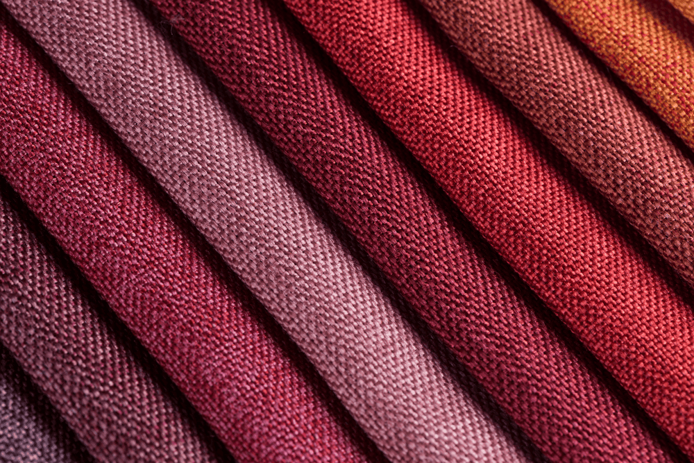 Close-up of folded fabric in shades of red, placed in a layered pattern at Hotel Westminster Paris