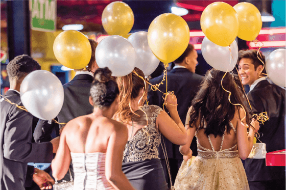 A group of people holding balloons at Amora Hotel Brisbane