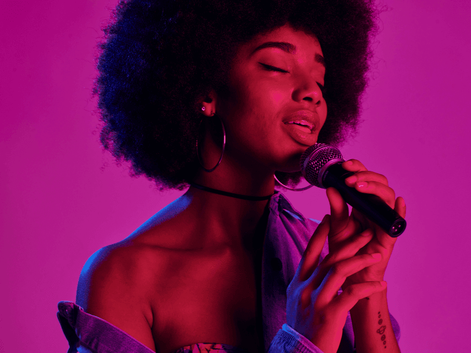 Vibrant image of a soulful singer performing with a microphone at Paradox Sydney, offering Sydney 5-star hotel deals
