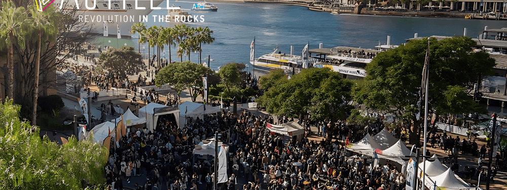 Crowds and tents at Bastille Day festivities with the Sydney Opera House visible near Novotel Sydney International Airport