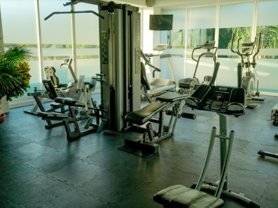 Interior of the gym with fitness machines at Gamma Hotels
