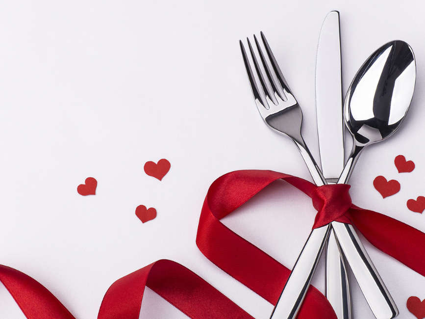 Cutlery with red ribbon and hearts