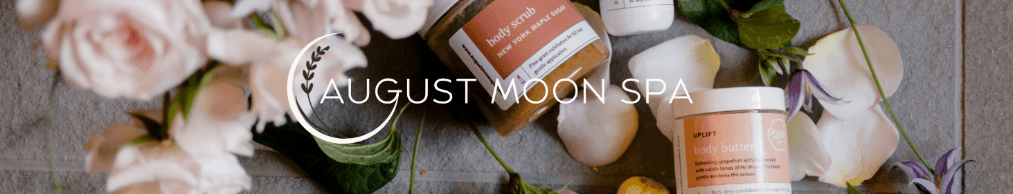 August Moon Spa text overlay with natural body scrub jars and pink rose petals around at La Tourelle Hotel and Spa