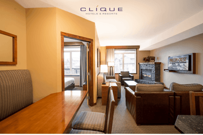 Spacious suite at Falcon Crest Lodge features a dining area, a comfortable living room with a fireplace