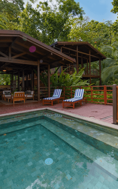 Pool with sunbeds & lounge area at Playa Cativo Lodge