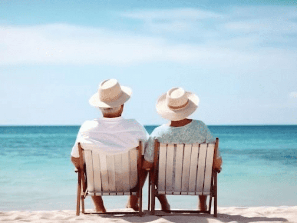 Elderly couple relaxing in beach chairs overlooking the turquoise Atlantic Ocean near Riviera Hotel South Beach