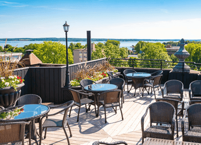 Rooftop patio with tables overlooking the water at Rodd Charlottetown, among the best hotels in charlottetown pei