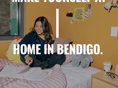 Student sitting on bed in a room at Living at La Trobe University student accommodation - The Villas
