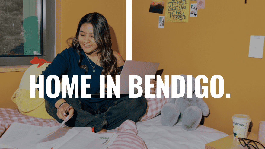 Student sitting on bed in a room at Living at La Trobe University student accommodation - The Villas
