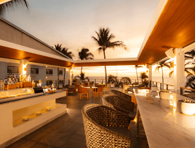 Sky Bar with wicker chairs, bar counter and ocean view at Buenaventura Grand Hotel and Spa