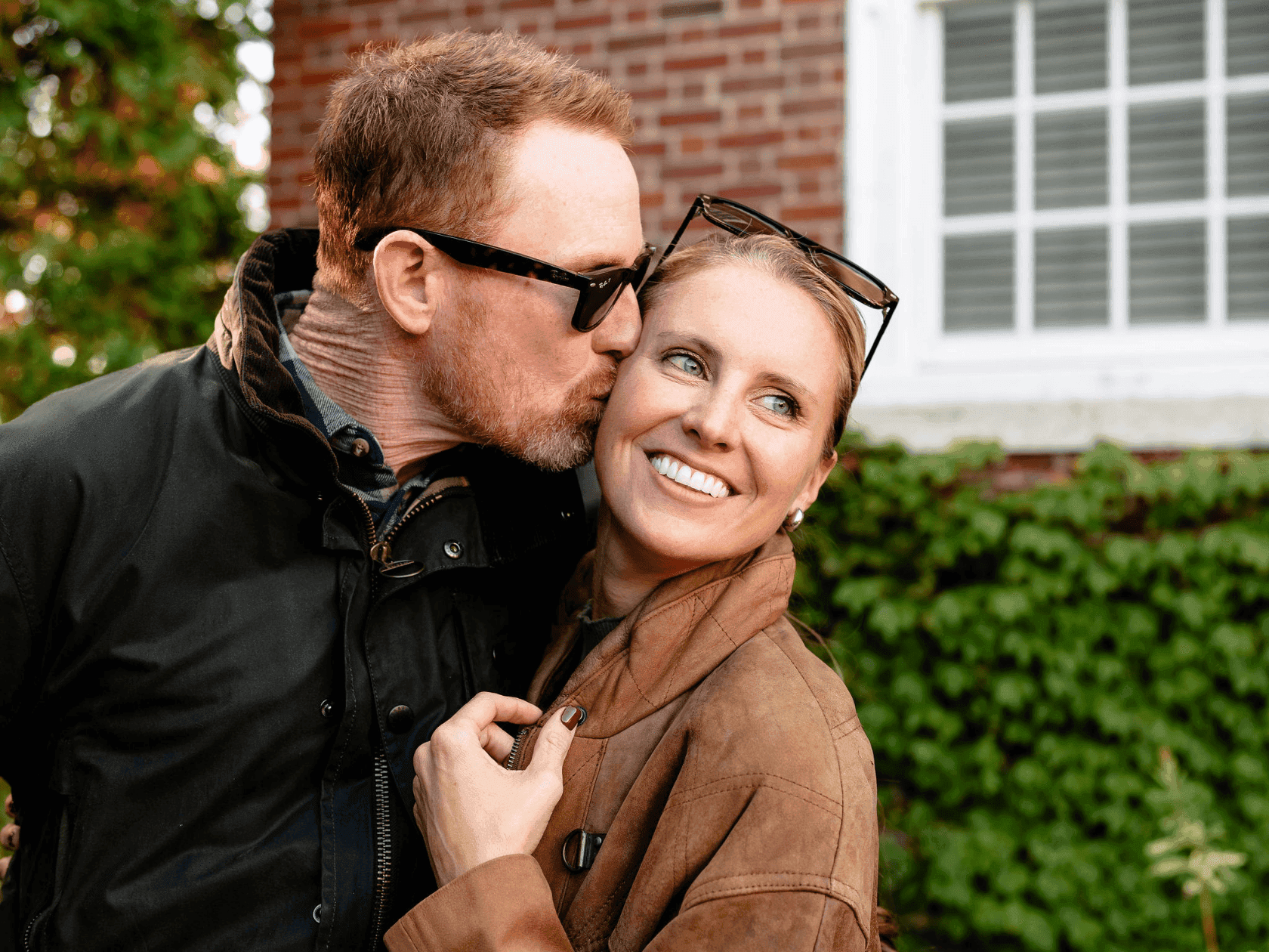 Couple embracing and smiling for a photo with The Valentine Plan.