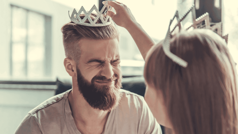 Daughter placing a crown on her dad’s head, celebrating Father’s Day at Novotel Sydney International Airport
