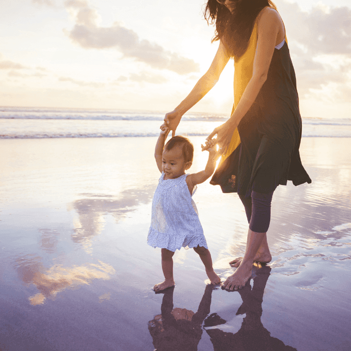 Young Asian Mother with Daughter on the beach at ICONA Avalon