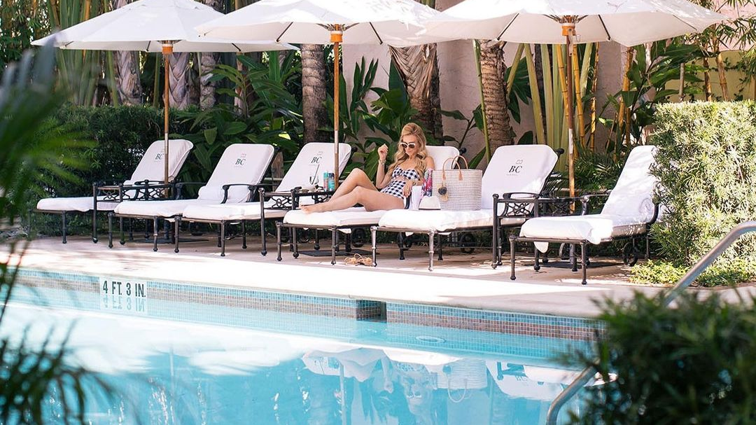 A girl lying on a lounger near the pool at Brazilian Court