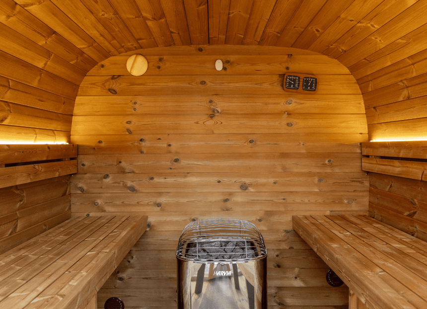 Traditional indoor wooden sauna room interior with tiered bench seating and bright warm light at Rodd Moncton hotel