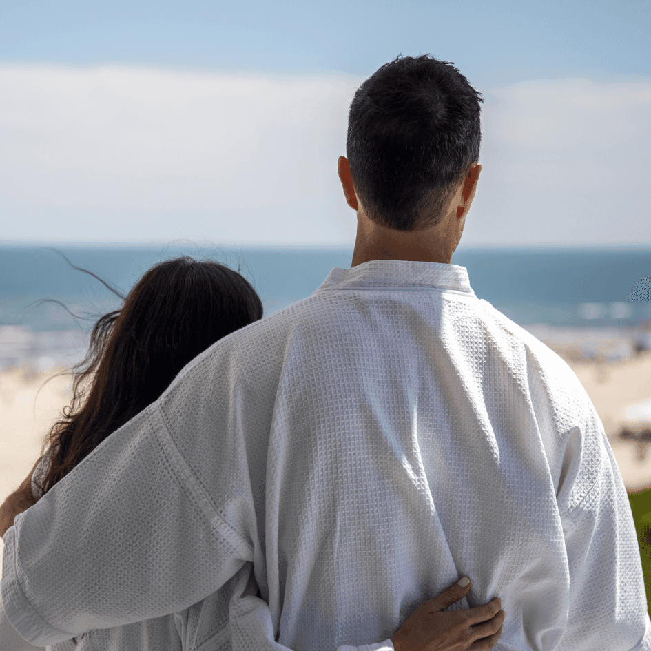 Couple embracing while looking at a beach view