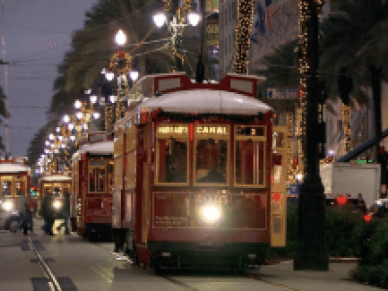 Streetcars at night in the city near La Galerie Hotel