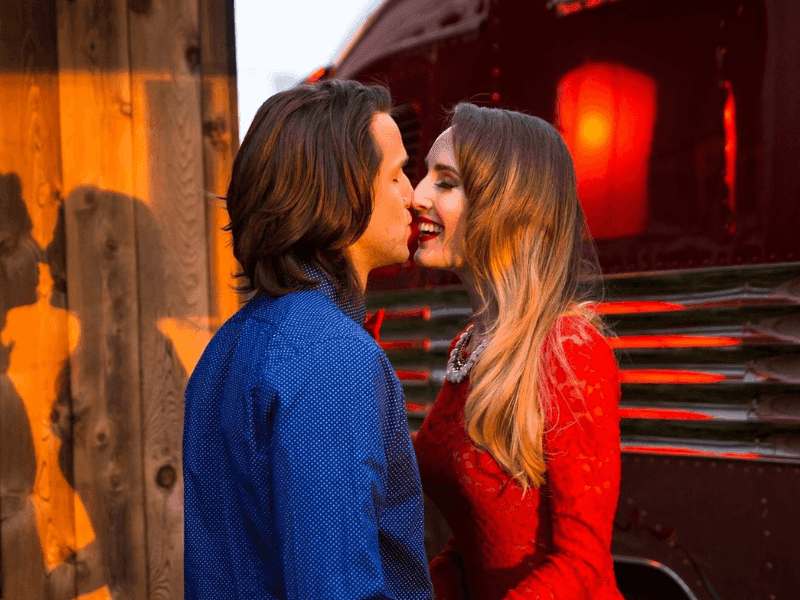 Romantic couple sharing a kiss outdoors at The Verb Hotel