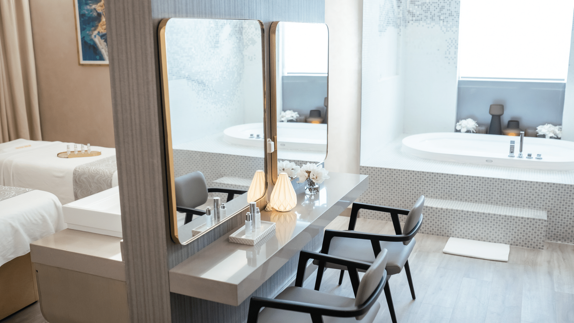 Spa relaxation area with comfortable chairs and a glimpse of treatment rooms and a jacuzzi at Paramount Hotel Midtown