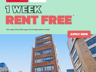 Modern student accommodation building with red brick facade and large windows under clear blue sky with promotional offer.