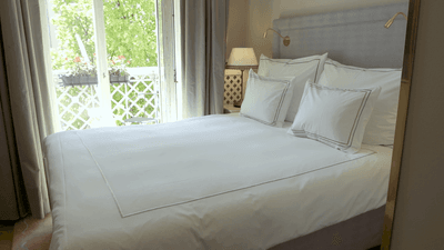 A king bed in the Standard Queen Room at The Sparrow Hotel