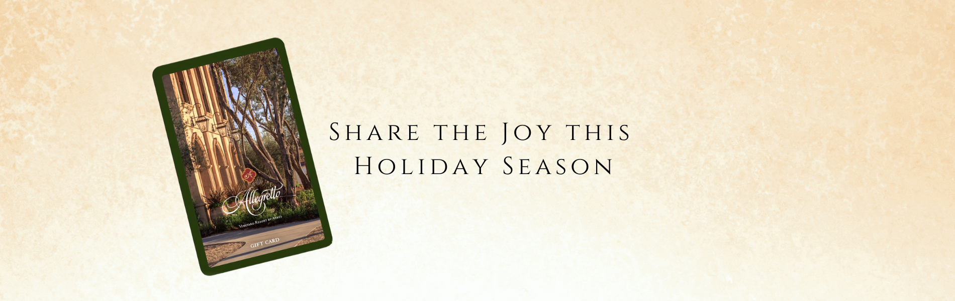 Share the Joy this holiday season. Allegretto Vineyard Resort gift card on beige background