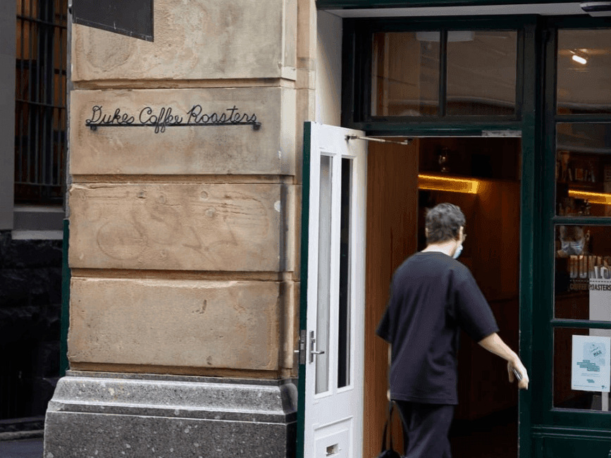 Outside shot of gentleman walking into café