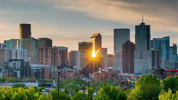 Denver skyline with the sun reflecting off buildings near Warwick Denver