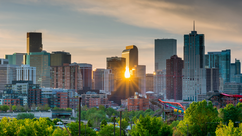Denver skyline with the sun reflecting off buildings near Warwick Denver