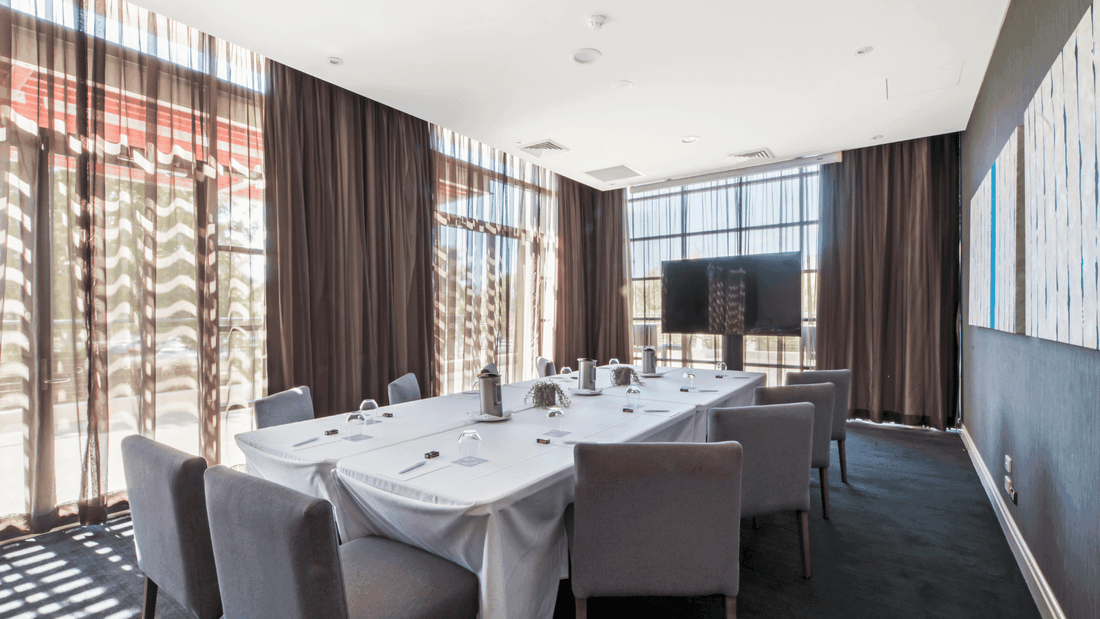 Boardroom Two with a long table, chairs, and abstract wall art at Mercure Kooindah Waters