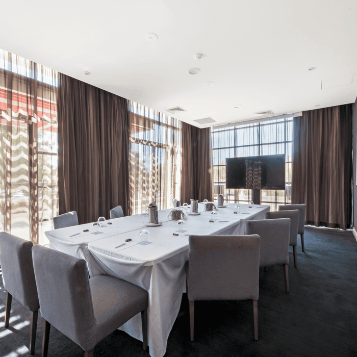 Boardroom Two with a long table, chairs, and abstract wall art at Mercure Kooindah Waters