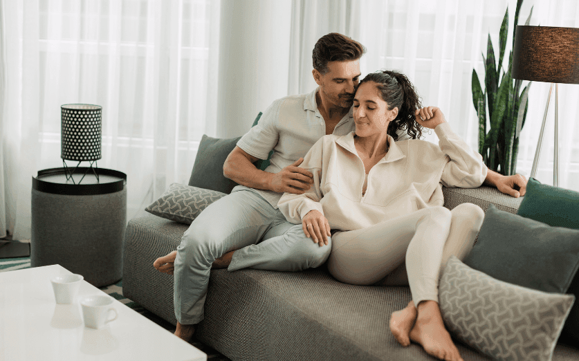 A couple enjoy a relaxing moment on the sofa at Warwick Le Crystal