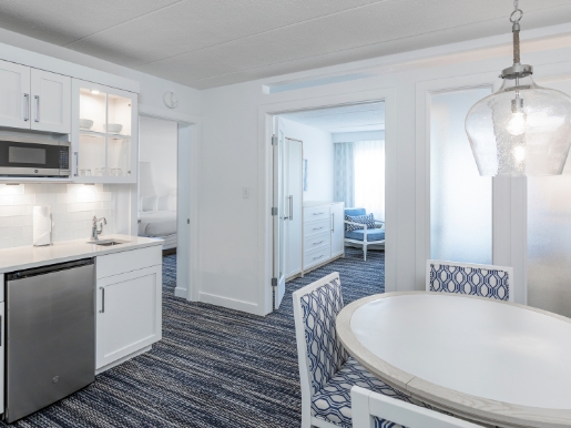 Signature 1 Bedroom 2 Bathroom Suite at ICONA Avalon with kitchenette, dining table, separate living room