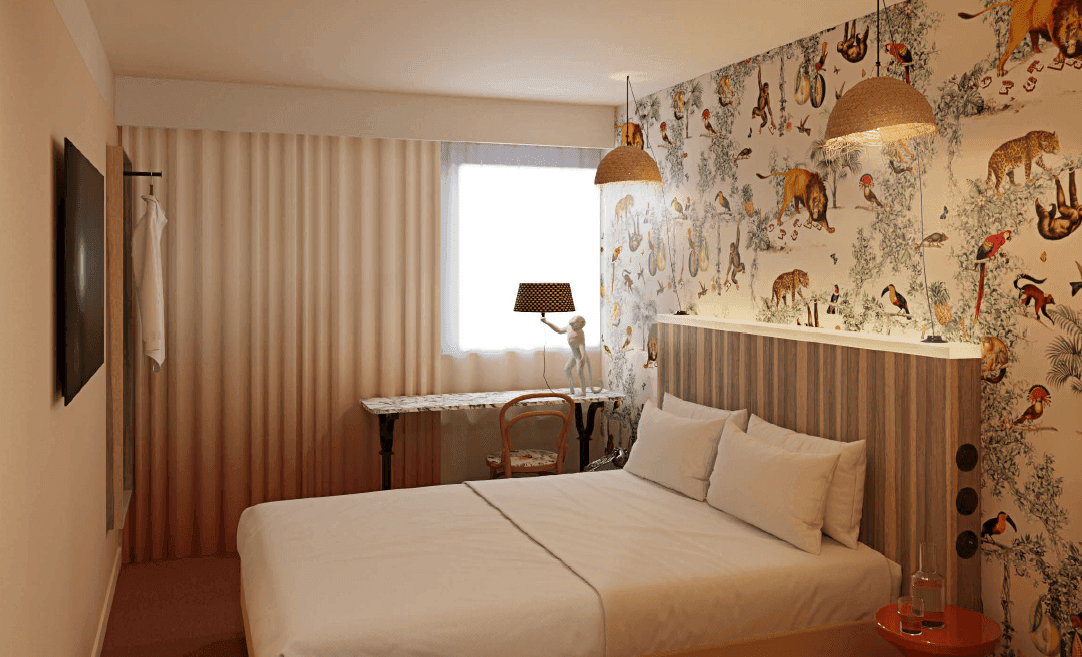 Double bed with a mural wallpaper at Kopster Hotel Paris Porte De Versailles
