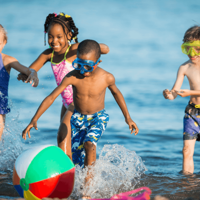 Children playing in the beach near ICONA Diamond Beach