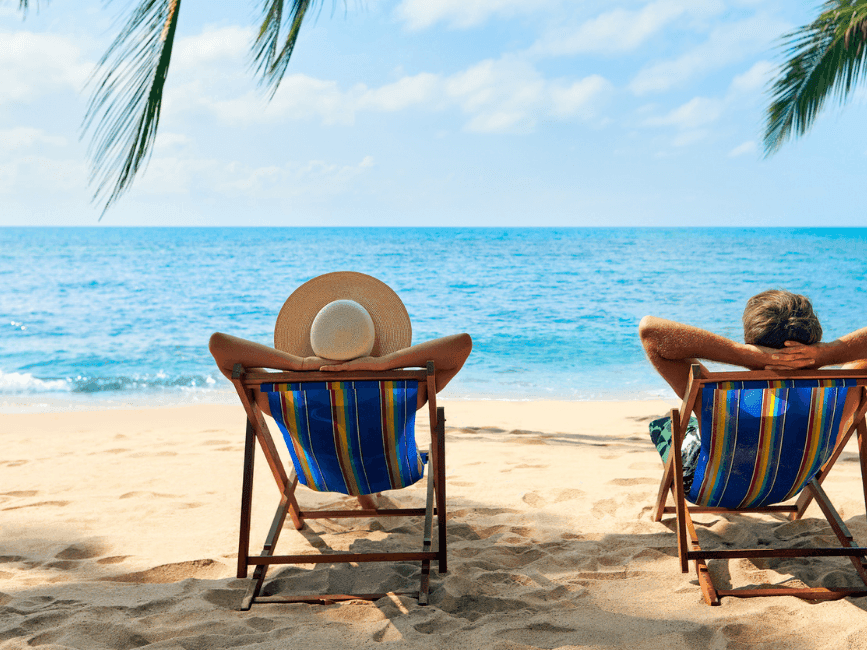 A couple sun lounging by the beach at Amora hotel