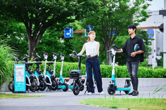 A couple standing next to bike rental luup near Park Hotel Kyoto