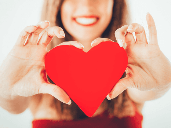 A woman holds up a Valentine's heart at our Wildwood Crest NJ hotel