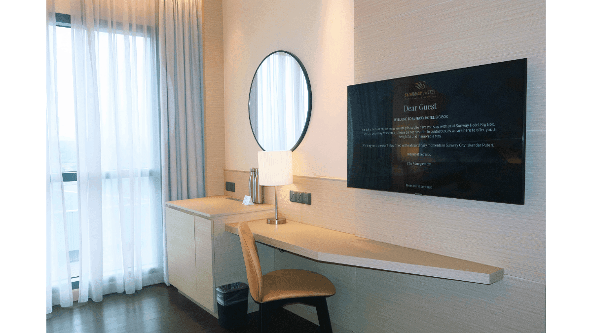 Comfy bed and lounge in Deluxe Executive King at Sunway Hotels & Resorts
