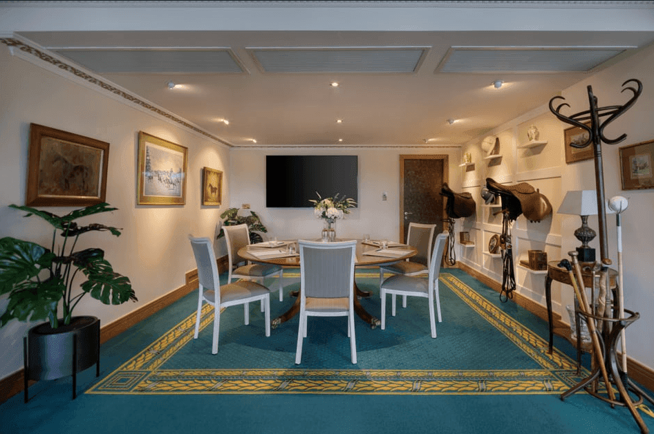 Round meeting table inside equestrain-themed room, perfect for business events in warwickshire at Polo Club Hotel