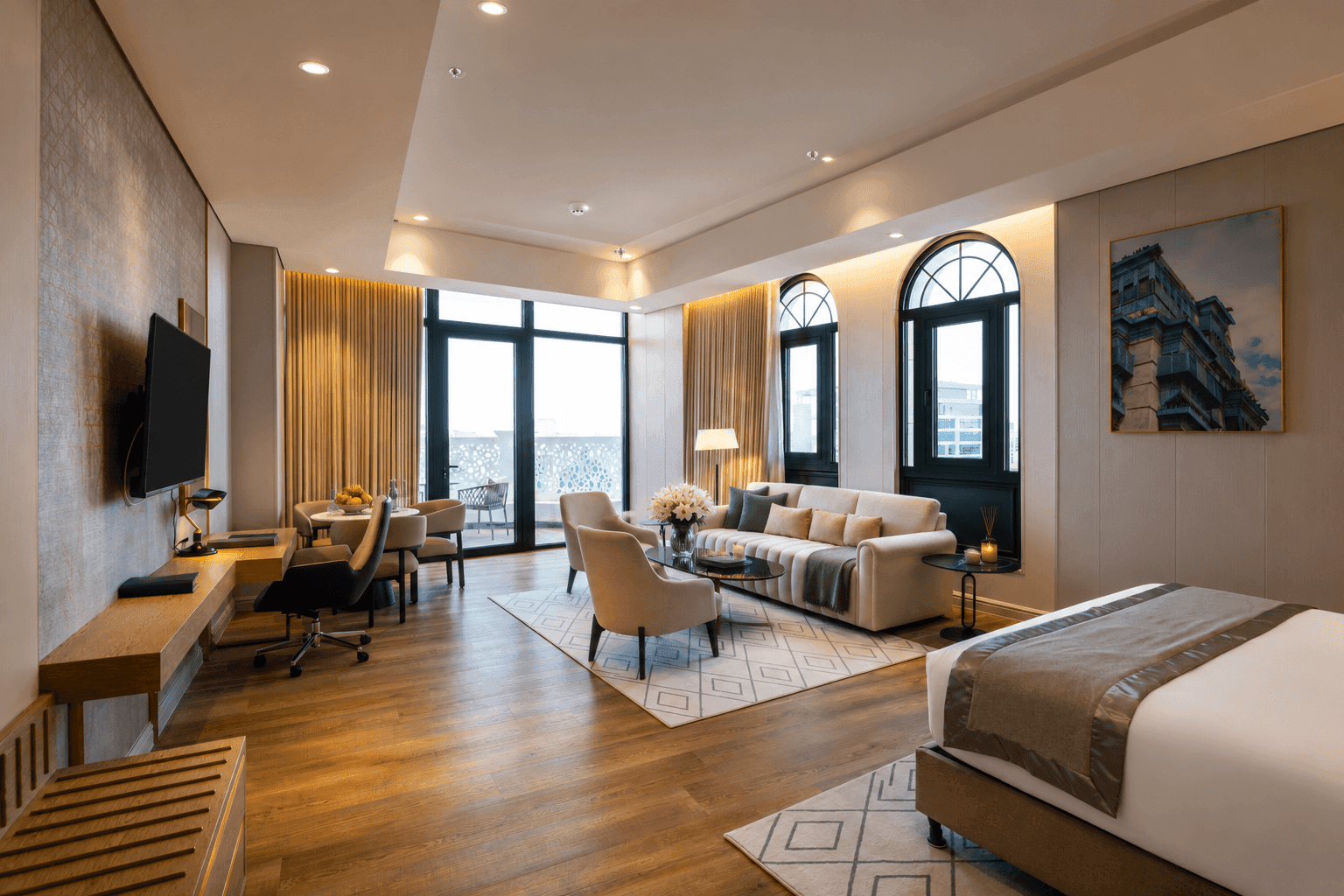 Executive Suite interior with king bed and lounge setup facing floor-to-ceiling glass doors at Naviti by Warwick Jeddah