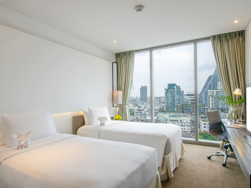 Twin beds in Deluxe Room with the city view at Amara Hotel BKK