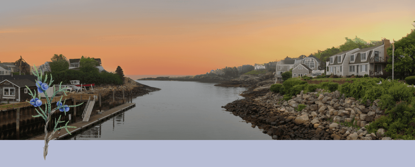 A wide view of a serene waterfront scene at sunset with houses and trees on both sides of the water.