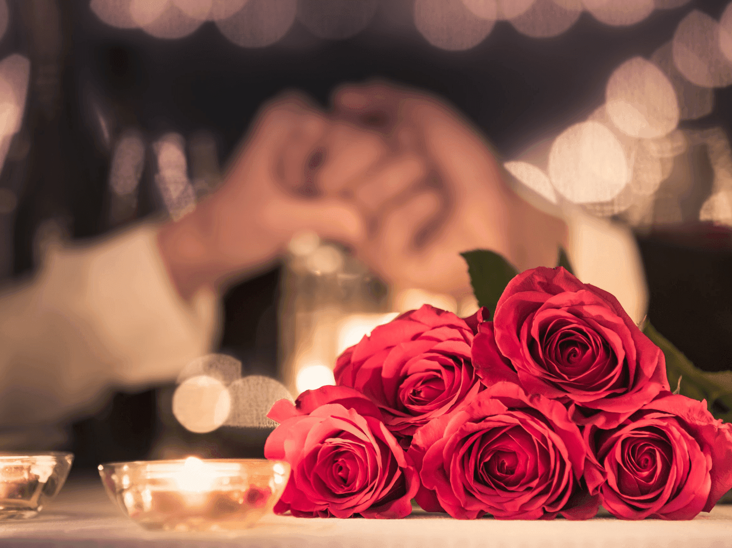 Central Hotel Panama Romantic Getaway Package with candlelit table with four red roses, romantic atmosphere.
