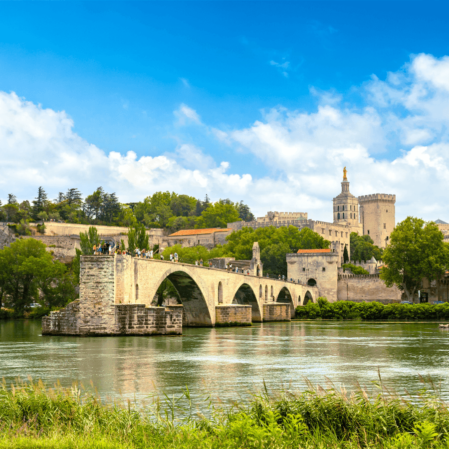 Scenic view of Pont Saint-Benezet bridge and surrounding architecture reflecting in calm river near ResidHotel Grand Avignon